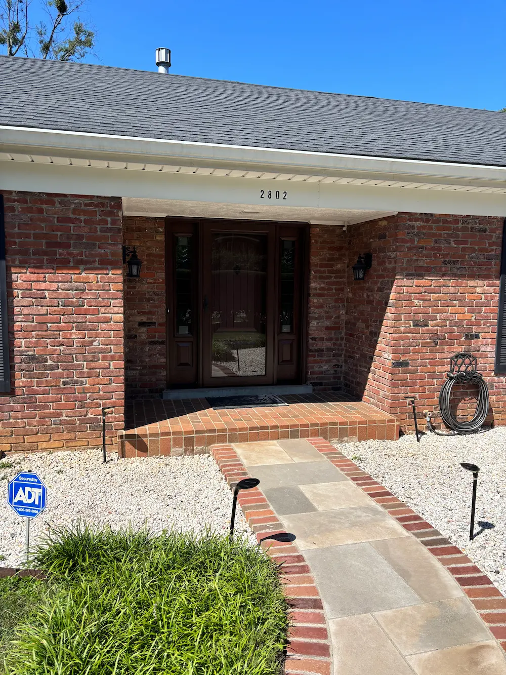 New Tudor Brown fiberglass entry door with sidelites and storm door